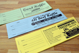 Raffle Tickets on Coloured Paper with Black Ink